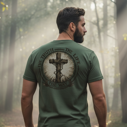 Man wearing a green t-shirt with a cross design in a forest