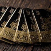 Set of gold and black gift cards on a wooden surface