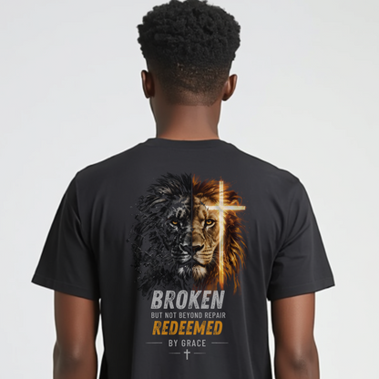 Person wearing a black t-shirt with a graphic design on the back featuring a lion and cross, with text.