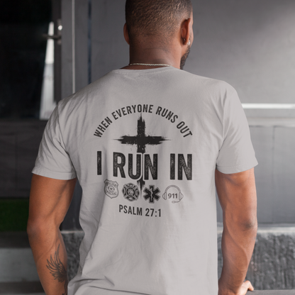 Man wearing a t-shirt with a motivational quote on the back in an indoor setting.
