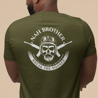 Man wearing a green t-shirt with a graphic design on the back against a beige background