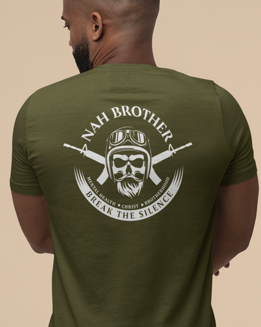 Man wearing a green t-shirt with a graphic design on the back against a beige background