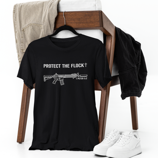 Black t-shirt with graphic design and text on a chair with shoes and pants.