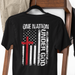 Black t-shirt with American flag design and 'One Nation Under God' text on a wooden rack.