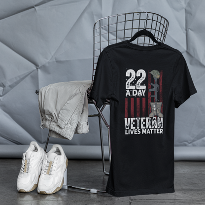 Black t-shirt with a Veterans Lives Matter design on a chair against a textured gray wall.